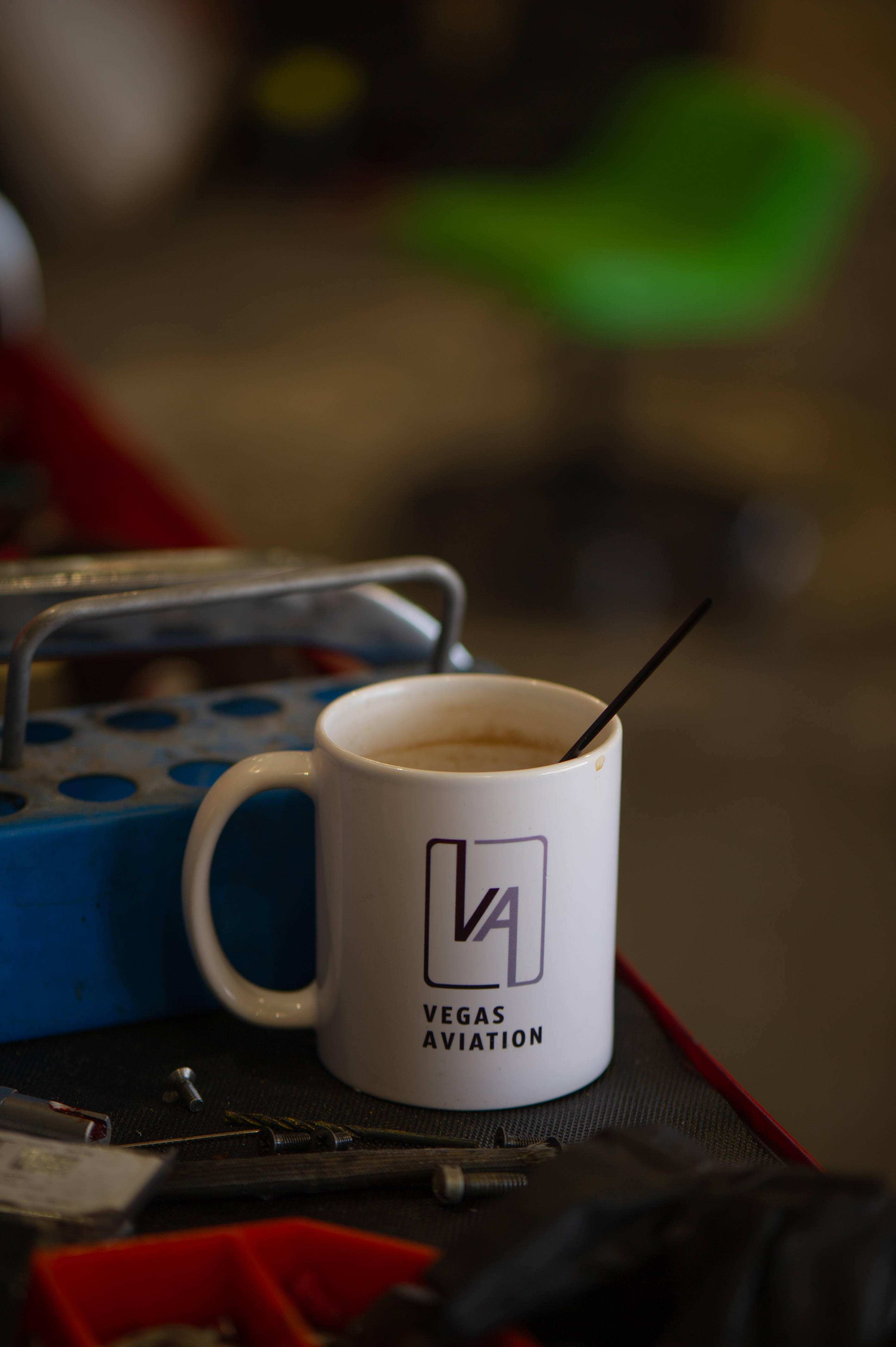 Coffee mug on a table in a Vegas Aviation's hangar