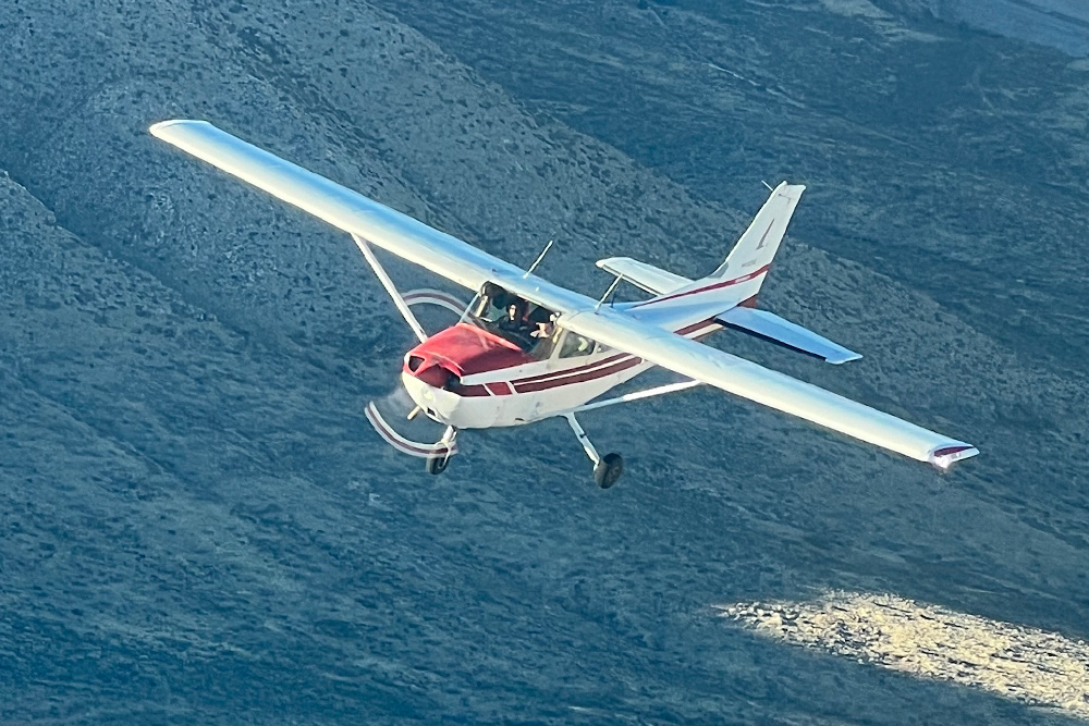 Aircraft flying over hills