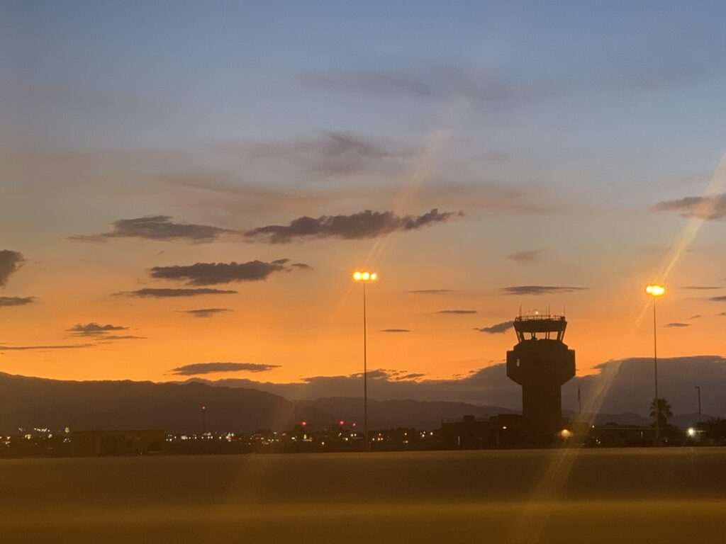 Airport control tower and city during the golden hour