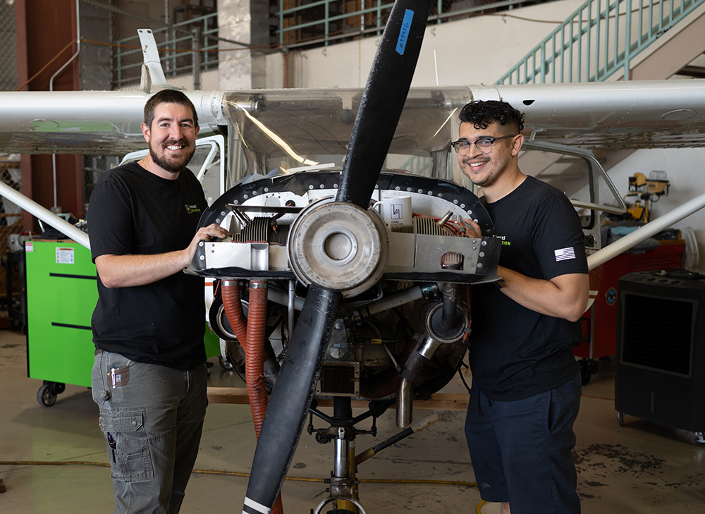 Two of Vegas Aviation mechanics working on an aircraft's engine