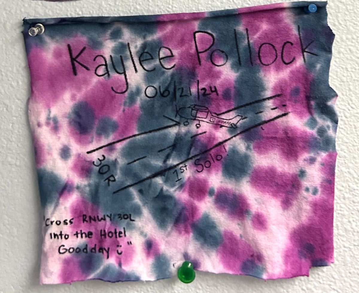 Kaylee Pollock's cut shirt with writing representing their first solo flight