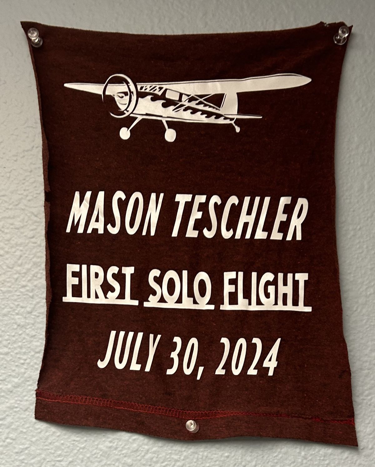 Mason Teschler's cut shirt with writing representing their first solo flight
